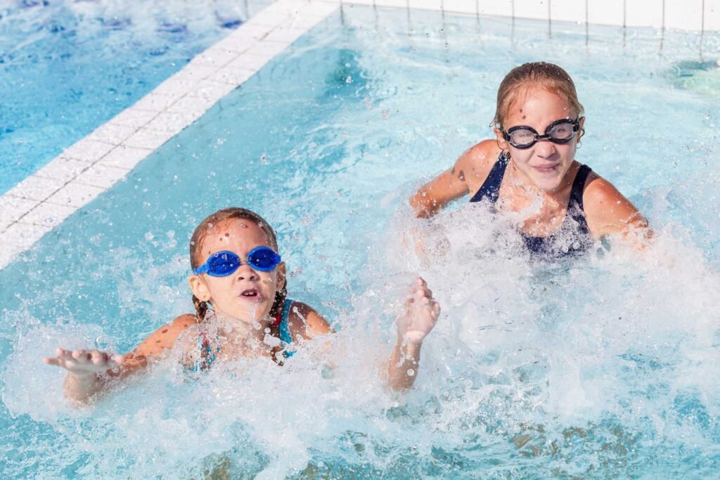 Two Happy Children Playing On The Swimming Pool At Pefffrm